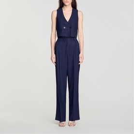 Model wearing navy blue sleeveless V-neck waistcoat and wide-leg trousers co-ord set, styled with strappy heeled sandals
