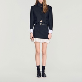 Model wearing Sandro Womens French Dress in black with white contrast cuffs and hem, styled with a belt and black loafers