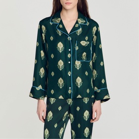 Model wearing Sandro green satin pyjama shirt with gold floral print, notch collar, button front and light blue piping trim