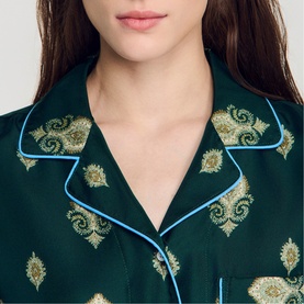 Model wearing Sandro green pyjama shirt with gold paisley embroidery and light blue piped collar, close-up detail shot