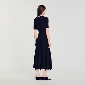 Model wearing Sandro Womens French Dress in black, featuring short sleeves, fitted bodice and tiered ruffle midi skirt, back view