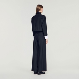 Model wearing Sandro Womens French Dress in black, rear view, styled with a white shirt and wide-leg silhouette