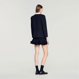 Model wearing Sandro Womens French Dress in black with white collar detail, styled with black ankle boots, rear view.