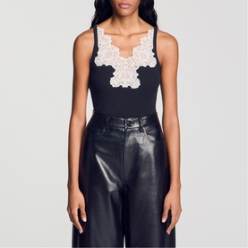 Model wearing Sandro Lace Trim Ribbed Tank Top in black with ivory lace trim neckline, styled with black leather wide-leg trousers.