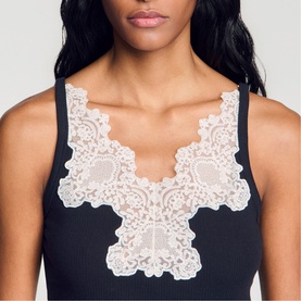 Model wearing Sandro Lace Trim Ribbed Tank Top in black with ivory floral lace V-neckline trim and fine straps.
