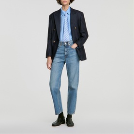 Model wearing Sandro sky blue striped shirt, styled with navy blazer, light wash straight-leg jeans and black loafers.