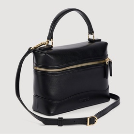 Sandro black leather top-handle bag with gold-tone zip detail, adjustable crossbody strap and structured silhouette.