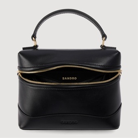 Sandro black leather top-handle bag, open to show interior, gold-tone zip and logo detail