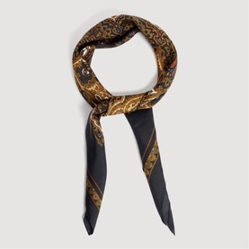 Sandro black and ochre baroque-print silk scarf twisted into a loop, featuring gold chain and floral motifs