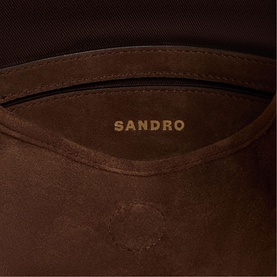 Sandro brown suede bag interior showing gold embossed logo and zip pocket detail