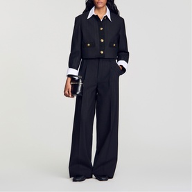 Model wearing Sandro Pinstripe High-Rise Wide Leg Trousers in black with wide-leg silhouette, styled with cropped jacket and white shirt.