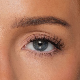 Close-up of model's eye wearing Kash Beauty Lash Lab Starter Pack false lashes in Natural Black, showing dramatic length and volume