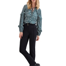 Model wearing Phase Eight black wide-leg trousers with gold button detail, styled with a teal spotted ruffle blouse and black heels