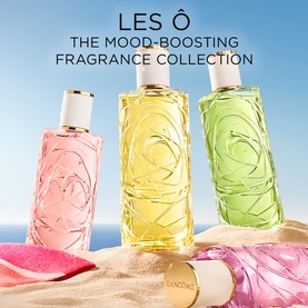 Lanc&ocirc;me Les &Ocirc; Mood-Boosting Fragrance Collection; three EDT bottles in pink, yellow and green displayed outdoors in sunlight.