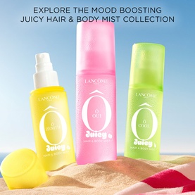 Lanc&ocirc;me &Ocirc; Oui Juicy Hair & Body Mist Collection in yellow, pink and green bottles displayed on sand with a lemon prop.
