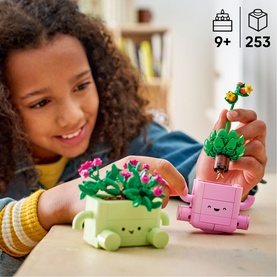 Lego Botanical toy set with green and pink character plant pots, held by a child. 253 pieces, ages 9+