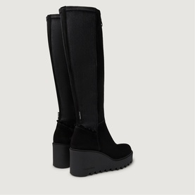 Black knee-high wedge boots with suede lower, stretch upper panel, back zip fastening, and chunky ridged platform sole