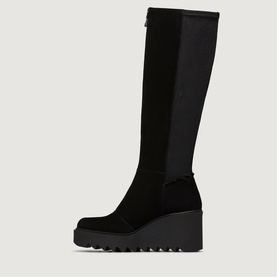Black suede knee-high wedge boot with chunky lug sole, stretch panel to back shaft and zip fastening, side product view