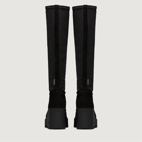 Black knee-high boots with stretch upper, chunky black platform sole, rear view showing pull-on silhouette