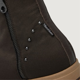 Marco Moreo brown boot close-up showing zip fastening, silver stud detail, and contrast gum sole edge
