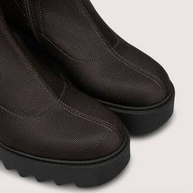 Marco Moreo brown textured fabric ankle boots with elasticated side panel and chunky black lug sole, close-up detail shot