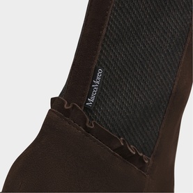 Marco Moreo brown suede boot close-up showing elasticated side panel and scalloped edge detail with brand label.