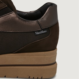 Marco Moreo trainer in brown suede, close-up of heel showing textured panel, branded tab, and tan chunky sole.