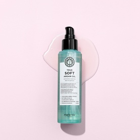 Maria Nila True Soft Argan Oil hair oil in teal pump bottle, shown against pink background with oil swatch