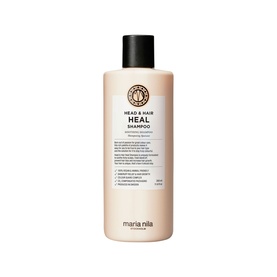 Maria Nila Head & Hair Heal Shampoo in a cream-toned bottle with black cap and branded label