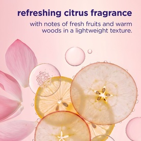 Maria Nila refreshing citrus fragrance detail showing fresh fruit slices, floral petals and droplets on pink background