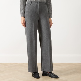 Model wearing Max Mara Weekend Dorata Straight-Leg Trousers in light grey with pressed creases, styled with black loafers and a grey knit top.