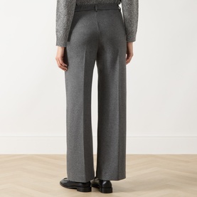 Model wearing Max Mara Weekend Dorata Straight-Leg Trousers in light grey with pressed creases, styled with a grey knit and black loafers