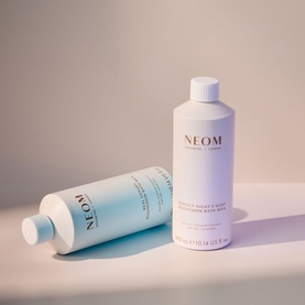 Neom Organics Body Lotion in Natural, shown alongside matching refill bottle in soft blue and white packaging