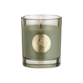 Penhaligon candle in sage green glass vessel with gold embossed brand seal, lit wick visible at top