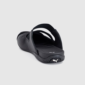 Puma black slide sandal, rear view showing heel counter, single strap, and white Puma logo on footbed