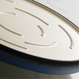 Tramontina blue casserole lid close-up, showing cream interior with embossed concentric ring detail and dark rim edge.
