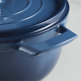 Tramontina blue cast iron casserole dish with fitted lid and dual side handles, close-up detail shot