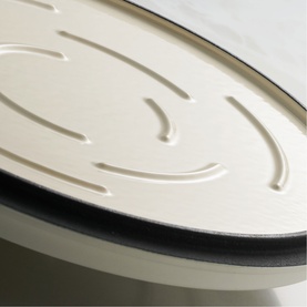 Tramontina Casserole lid close-up in latte, showing embossed detail and black rim edge
