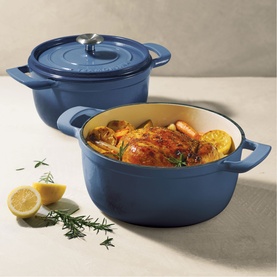 Tramontina blue cast iron casserole dishes styled with roast chicken, vegetables and lemon, shown in two sizes