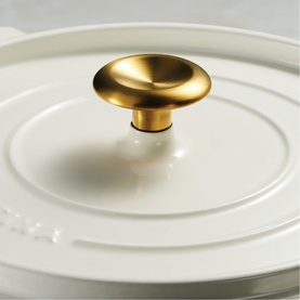 Tramontina Casserole in latte with close-up of brass-tone knob handle on fitted lid
