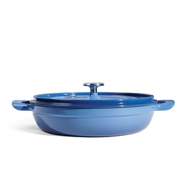 Tramontina blue cast iron shallow casserole pan with lid and dual handles, viewed from slight angle