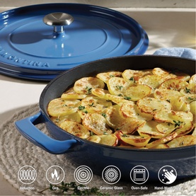 Tramontina blue cast iron pan with lid, filled with roasted sliced potatoes, with compatibility icons shown below