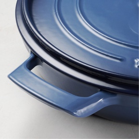 Tramontina blue ceramic pan with fitted lid, showing side handle detail and smooth glazed finish.