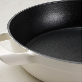Tramontina Saute Pan in latte with black non-stick interior, dual handles, viewed from above on marble surface