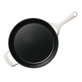 Tramontina latte cast iron skillet with black interior, long handle and small helper handle, viewed from above.