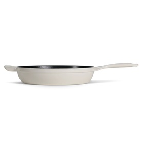 Tramontina latte cast iron skillet with black interior, long handle and side helper handle, side profile view