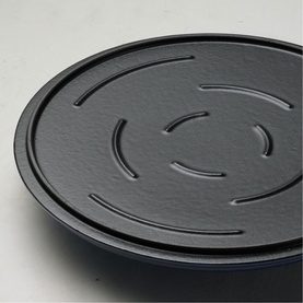 Tramontina blue skillet, close-up of textured non-stick surface with embossed circular pattern on lid or base.