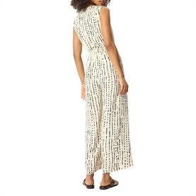 Model wearing Whistles cream sleeveless maxi dress with black abstract stripe print, shown from the back, with side split detail.
