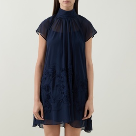 Model wearing Jonathan Simkhai Aviel Floral Appliqu&eacute; Mini Dress in Midnight, with gathered high neck, cap sleeves and soutache embroidery on sheer