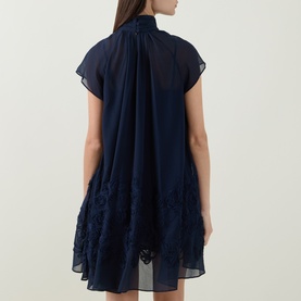 Model wearing Jonathan Simkhai Aviel Floral Appliqu&eacute; Mini Dress in Midnight, showing draped back, gathered neckline, cap sleeves and floral